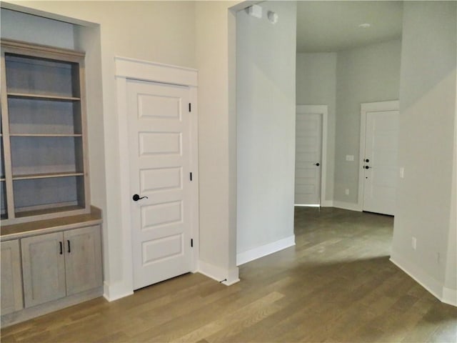 interior space with baseboards and wood finished floors