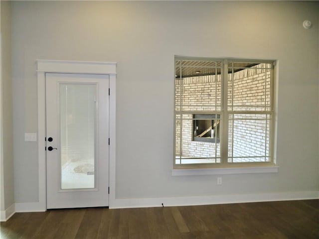 interior space with baseboards and wood finished floors