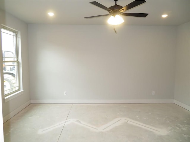 empty room with baseboards, concrete flooring, and a wealth of natural light