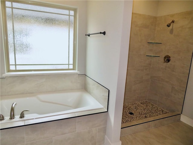 bathroom featuring tiled shower, a garden tub, and tile patterned flooring