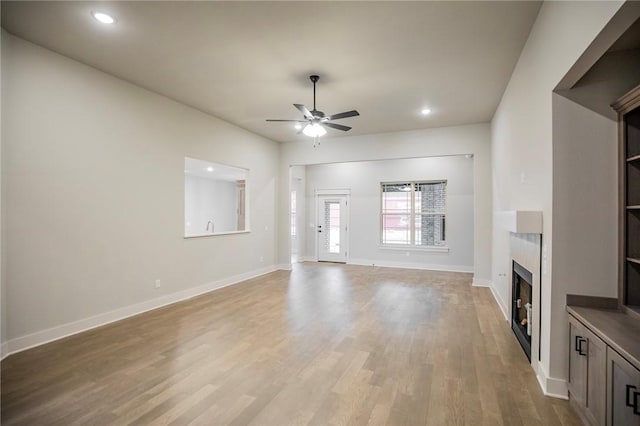 304 Doral Dr, Cave Springs, AR 72718 - unfurnished living room with a ceiling fan, light wood-style flooring, a fireplace, baseboards, and recessed lighting