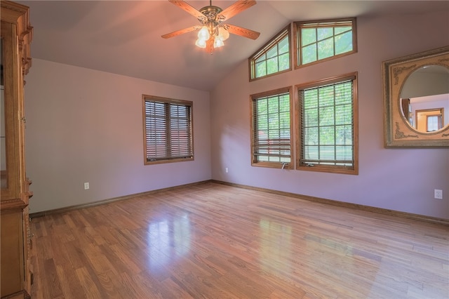 unfurnished room featuring ceiling fan, lofted ceiling, and light hardwood / wood-style flooring