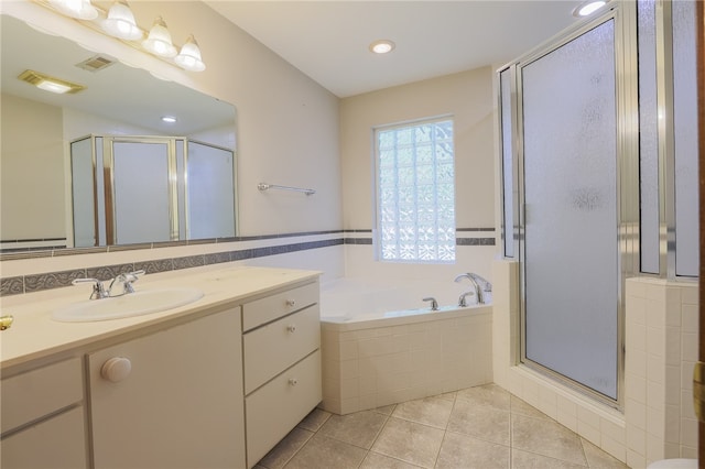 bathroom featuring tile patterned flooring, vanity, and separate shower and tub