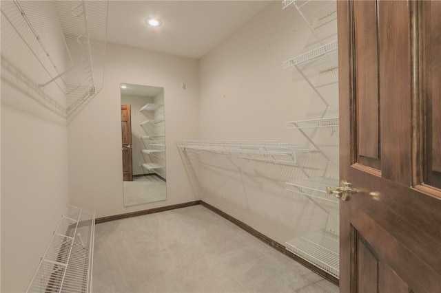 spacious closet with light colored carpet