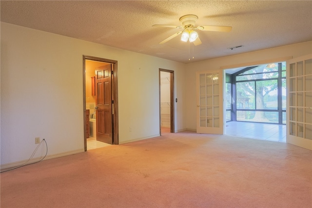 interior space with a textured ceiling, light carpet, ceiling fan, and french doors