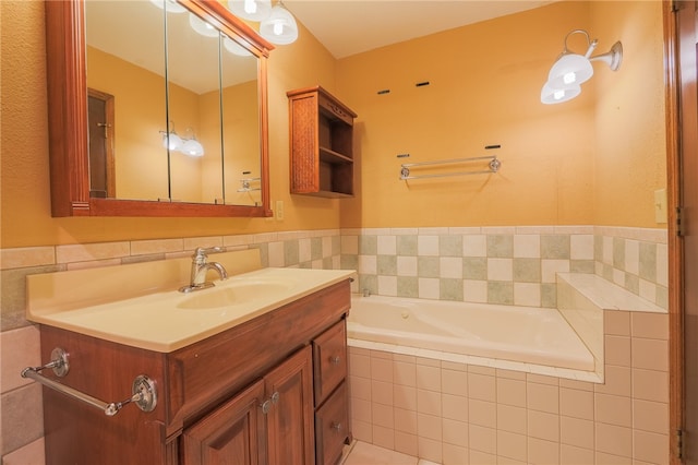 bathroom with tiled tub and vanity