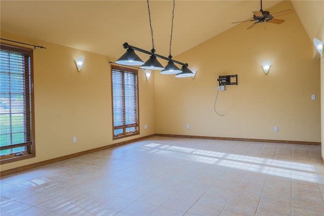 tiled spare room with lofted ceiling and ceiling fan