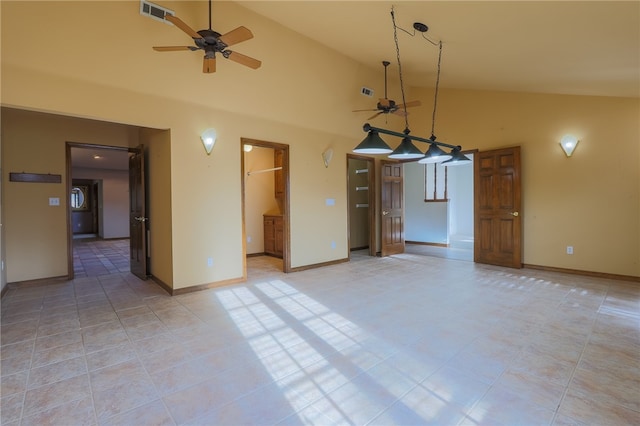 tiled spare room with ceiling fan and high vaulted ceiling