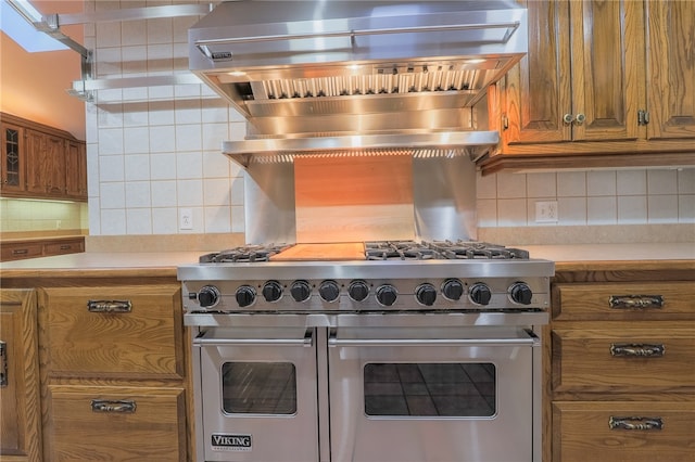 kitchen with decorative backsplash and range with two ovens