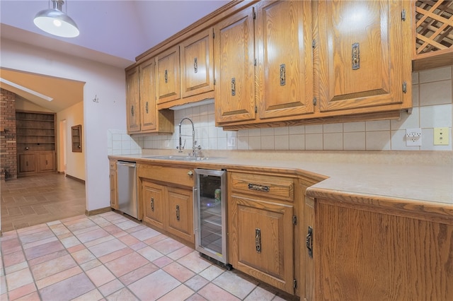 kitchen with beverage cooler, backsplash, stainless steel dishwasher, and sink