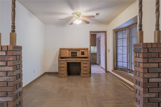 unfurnished living room featuring parquet flooring, ceiling fan, and a textured ceiling