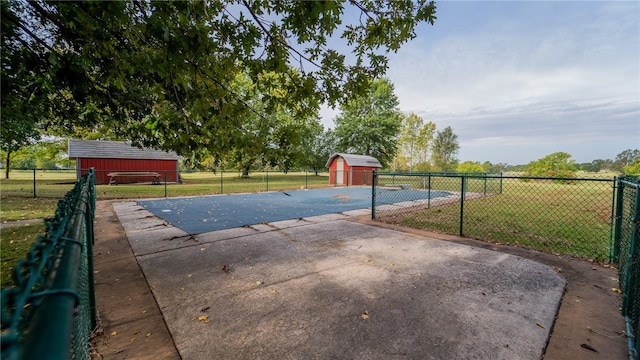 exterior space featuring a storage shed and a lawn