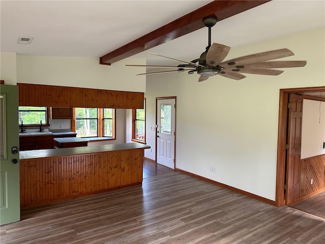 kitchen featuring sink, kitchen peninsula, vaulted ceiling with beams, dark hardwood / wood-style flooring, and ceiling fan