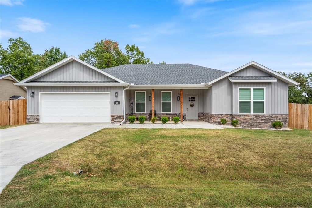 ranch-style house featuring a front yard and a garage