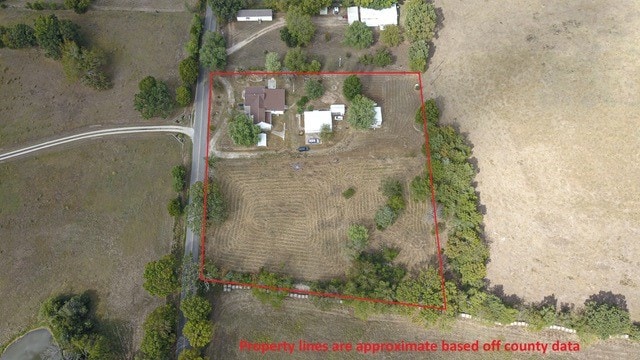 birds eye view of property featuring a rural view