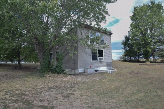 view of home's exterior with a lawn and crawl space