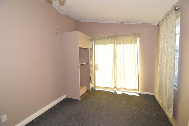 unfurnished room featuring carpet flooring and baseboards
