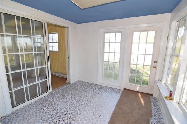entryway featuring baseboards and a baseboard heating unit