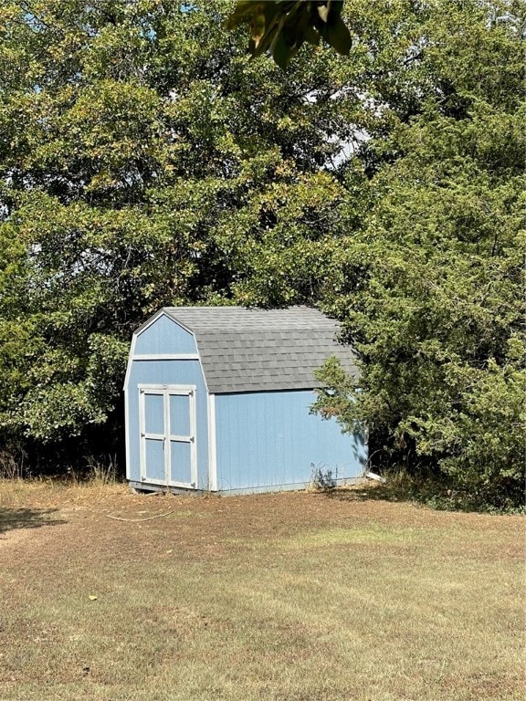 view of outdoor structure with a lawn