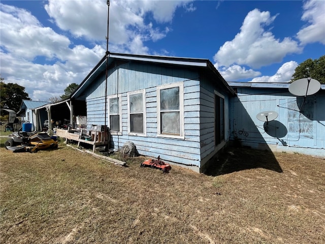 view of property exterior featuring a lawn