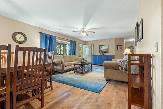 living area featuring light wood-style floors and ceiling fan