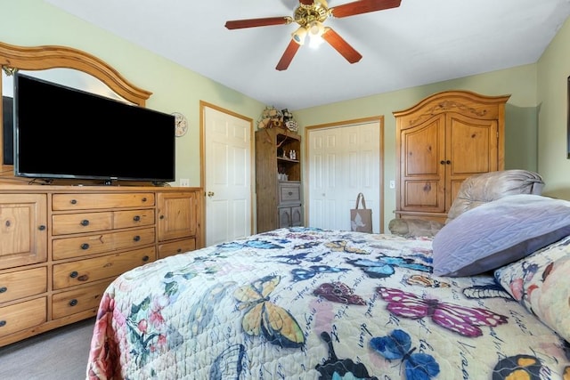 carpeted bedroom with ceiling fan and a closet