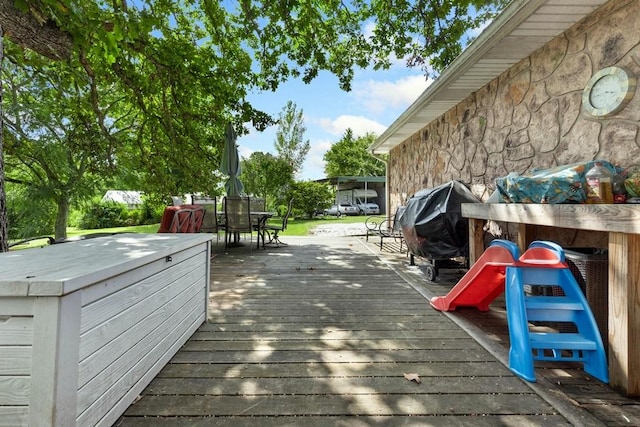 deck with outdoor dining area and area for grilling