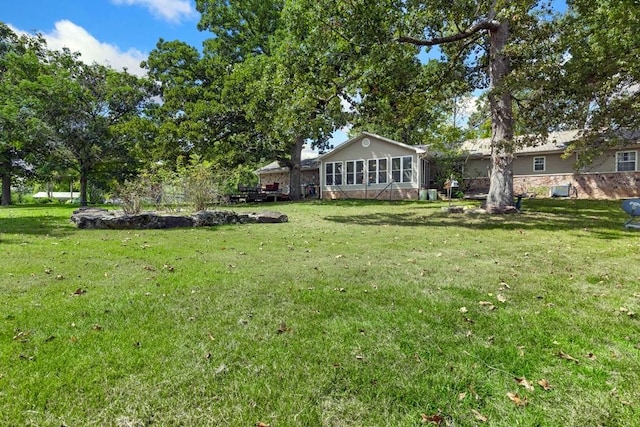 view of yard with a sunroom