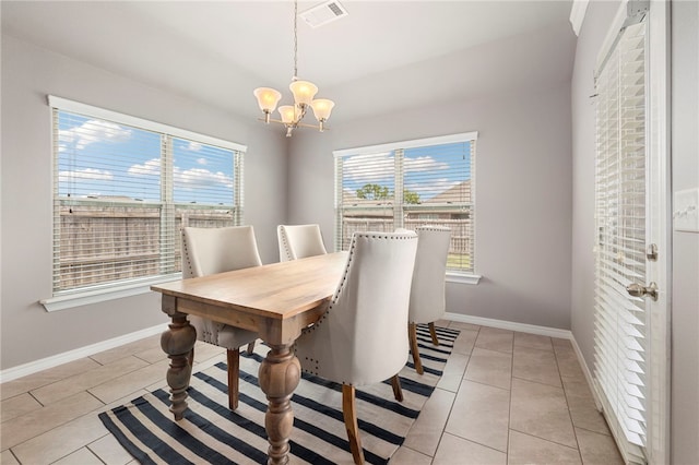 tiled dining space with a notable chandelier