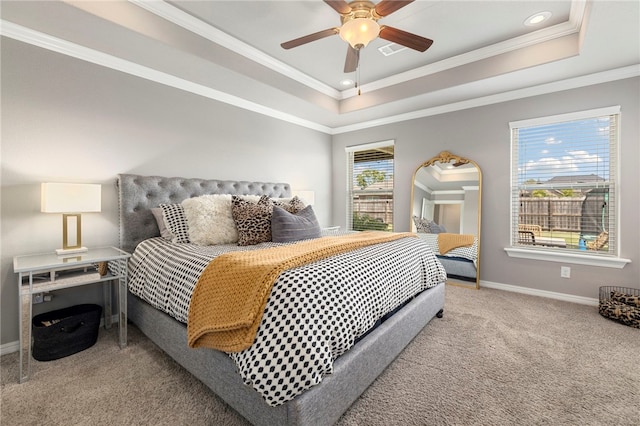 bedroom with ceiling fan, ornamental molding, and a tray ceiling