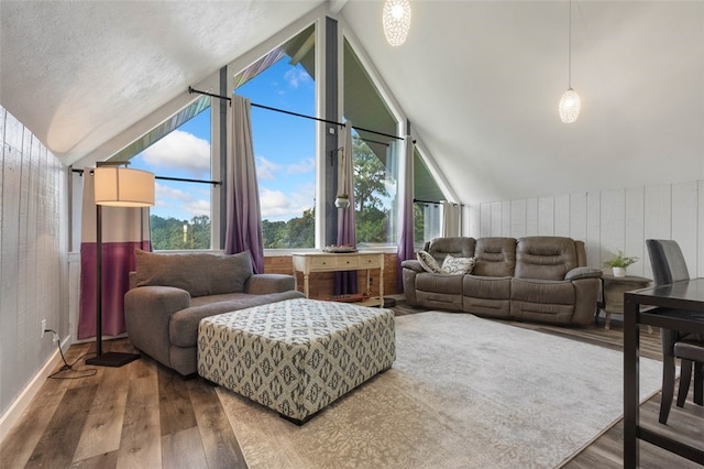 living room featuring lofted ceiling, wood walls, and hardwood / wood-style floors