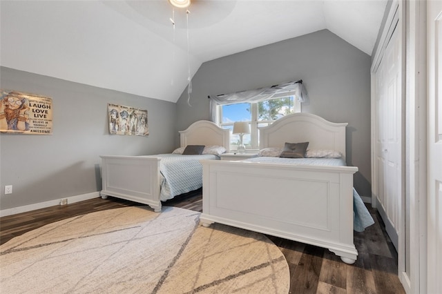 bedroom featuring lofted ceiling, dark wood-type flooring, and ceiling fan