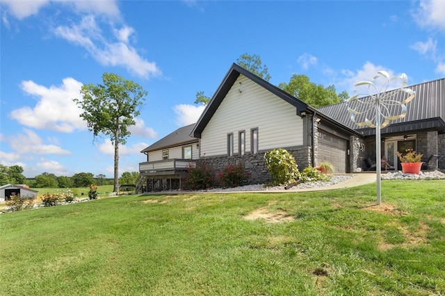 view of side of property featuring a yard and a garage