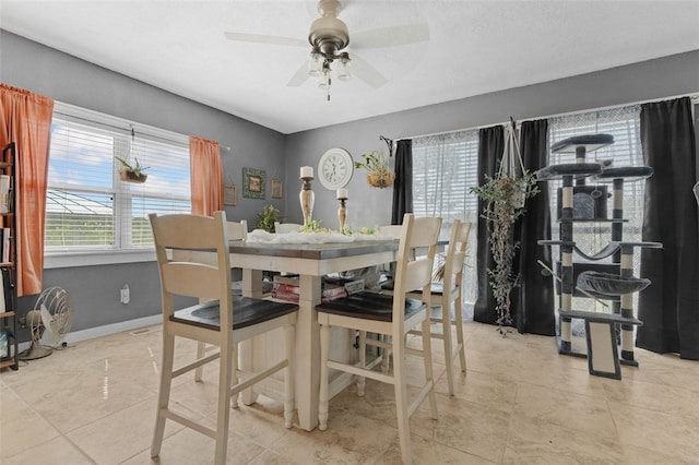 tiled dining area featuring ceiling fan