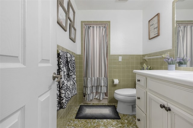 bathroom featuring vanity, tile patterned floors, a shower with curtain, tile walls, and toilet