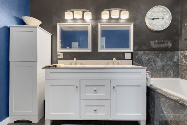 bathroom with vanity and a relaxing tiled tub