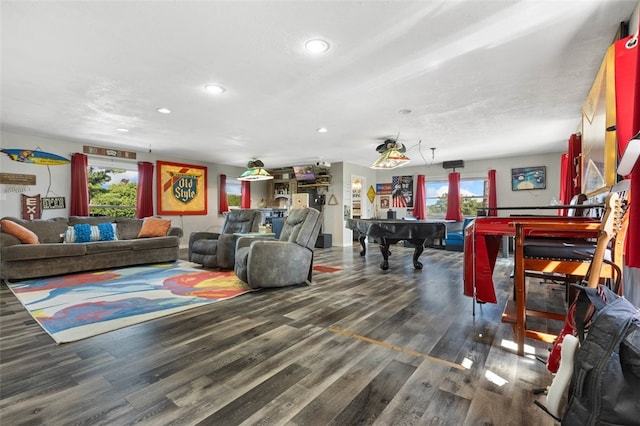 living room with a textured ceiling, billiards, dark wood-type flooring, and a healthy amount of sunlight