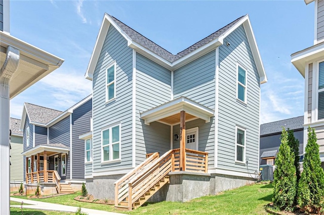 view of front of property featuring a porch, central AC unit, and a front yard