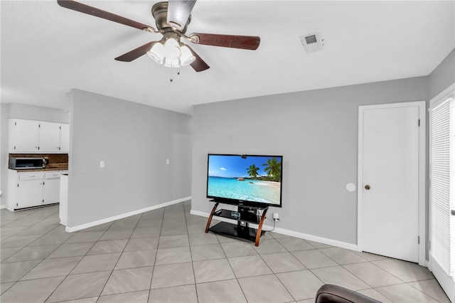 unfurnished living room with ceiling fan and light tile patterned floors