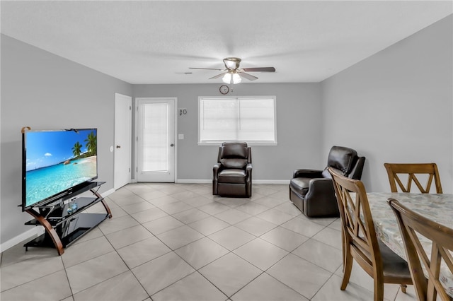 living room with ceiling fan and light tile patterned floors