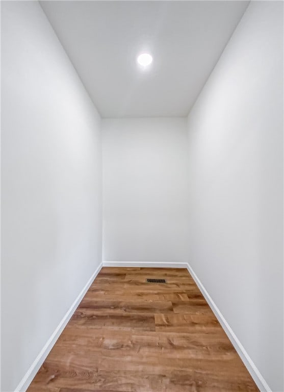 empty room with hardwood / wood-style flooring