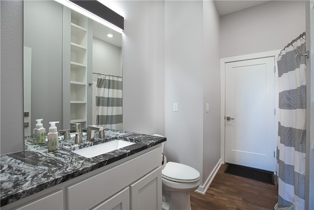 bathroom featuring a shower with curtain, vanity, toilet, and hardwood / wood-style flooring