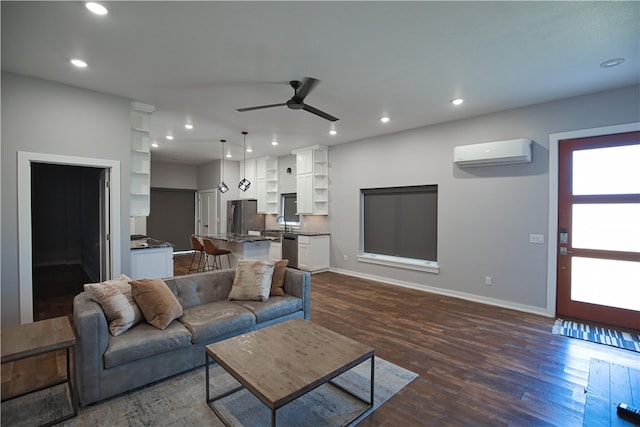 living room featuring ceiling fan, dark wood-type flooring, and a wall mounted AC