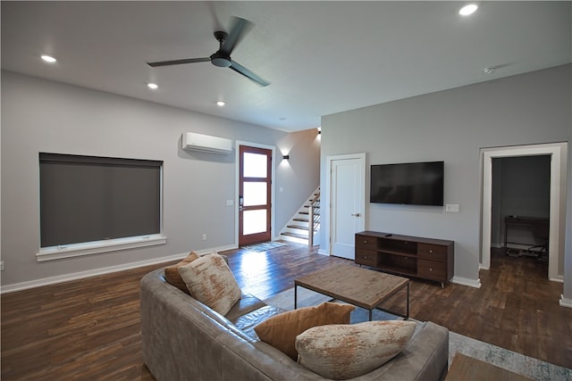 living room featuring ceiling fan, dark hardwood / wood-style flooring, and an AC wall unit