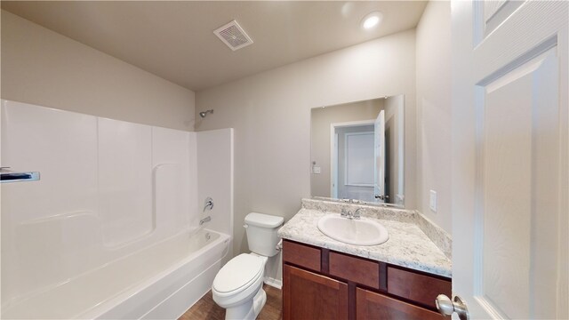 full bathroom featuring vanity, toilet, shower / bathing tub combination, and hardwood / wood-style flooring