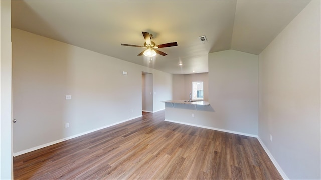 unfurnished living room featuring ceiling fan, hardwood / wood-style flooring, lofted ceiling, and sink