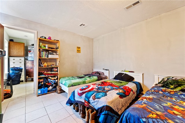 tiled bedroom with a textured ceiling