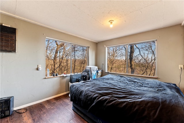 bedroom with dark wood-type flooring and a textured ceiling