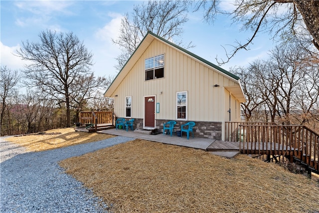 rear view of house featuring a patio area and a wooden deck