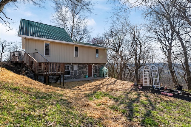 rear view of house featuring a deck